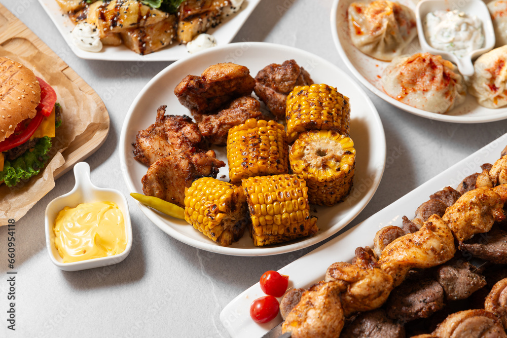 set of different grilled meat and corn on a with plates, grilled food for banner and menu set of different grilled meat and corn on a with plates, grilled food for banner and menu