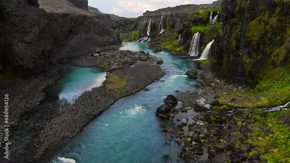 fantasy like canyon valley of tears with several waterfalls falling in the blue river with lush vegetation in the desertic lava landscape Sigoldugljufur iceland fantasy like canyon valley of tears with several waterfalls falling in the blue river with lush vegetation in the desertic lava landscape Sigoldugljufur iceland