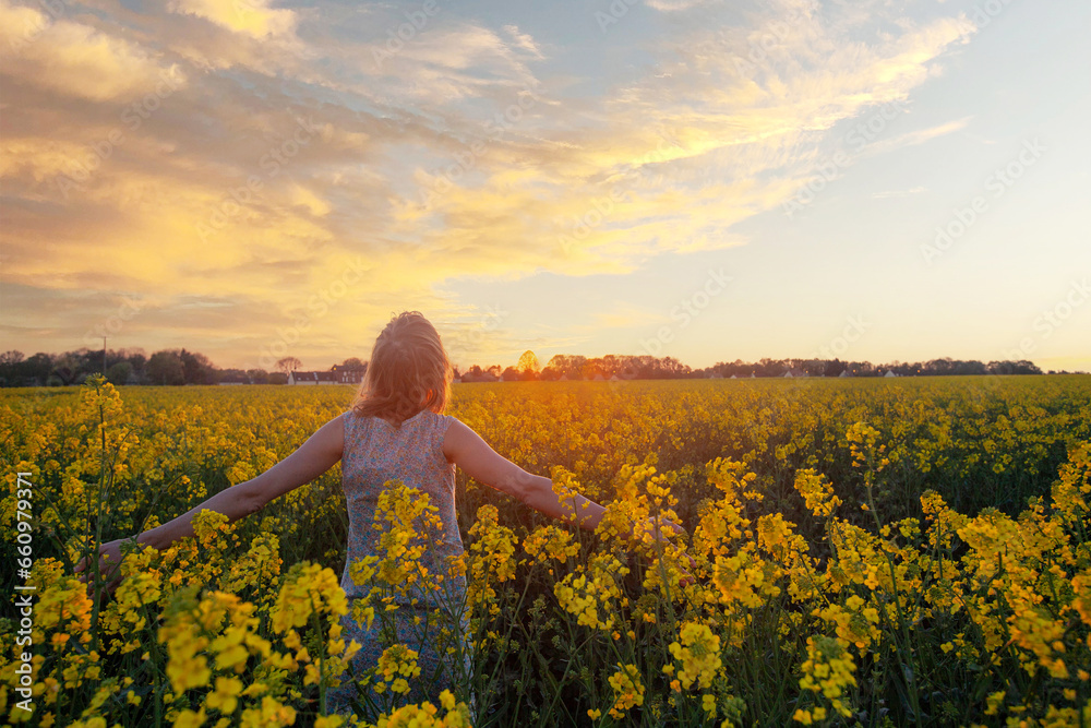 Fototapeta premium wellness, woman in flower field in nature, wellbeing