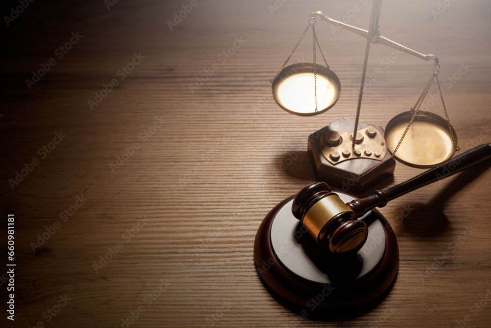 Judge gavel and weight scale on wooden table