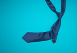 Father's Day concept. Top view of a necktie on a blue background.