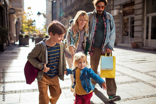 Young family walking and shopping in the city photo