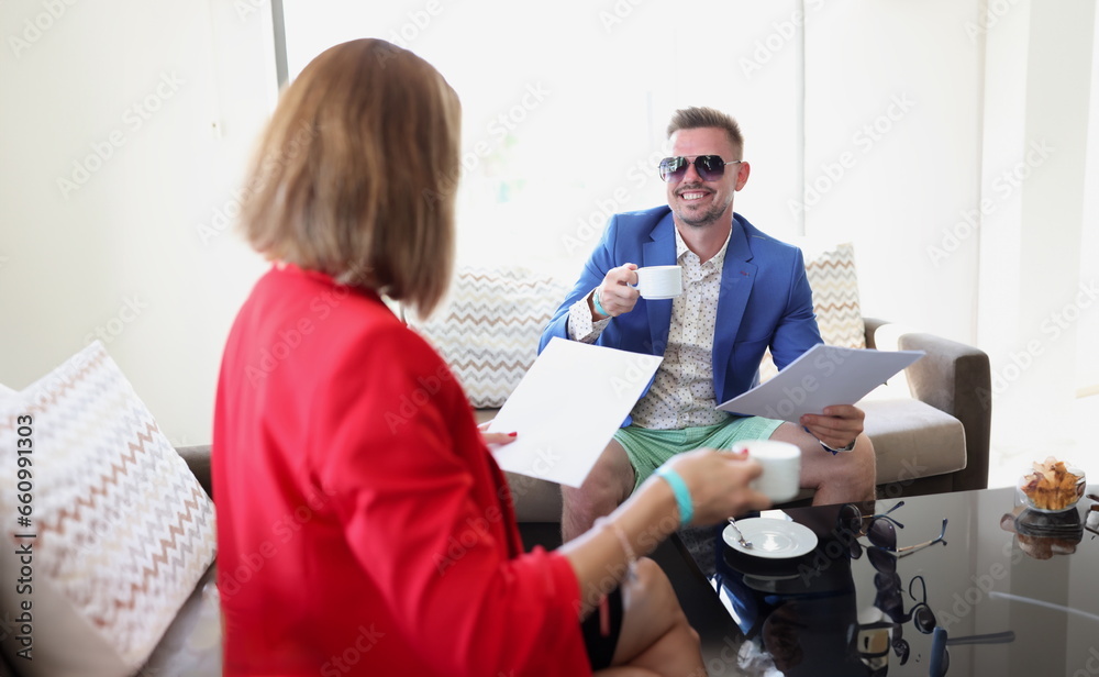 Obraz premium Businesswoman and businessman drink coffee and discuss signing an agreement. Business meetings and introduction of negotiations. concept