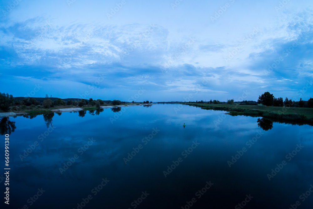 Evening natural landscape on the Oder River. Border of Germany and Poland.