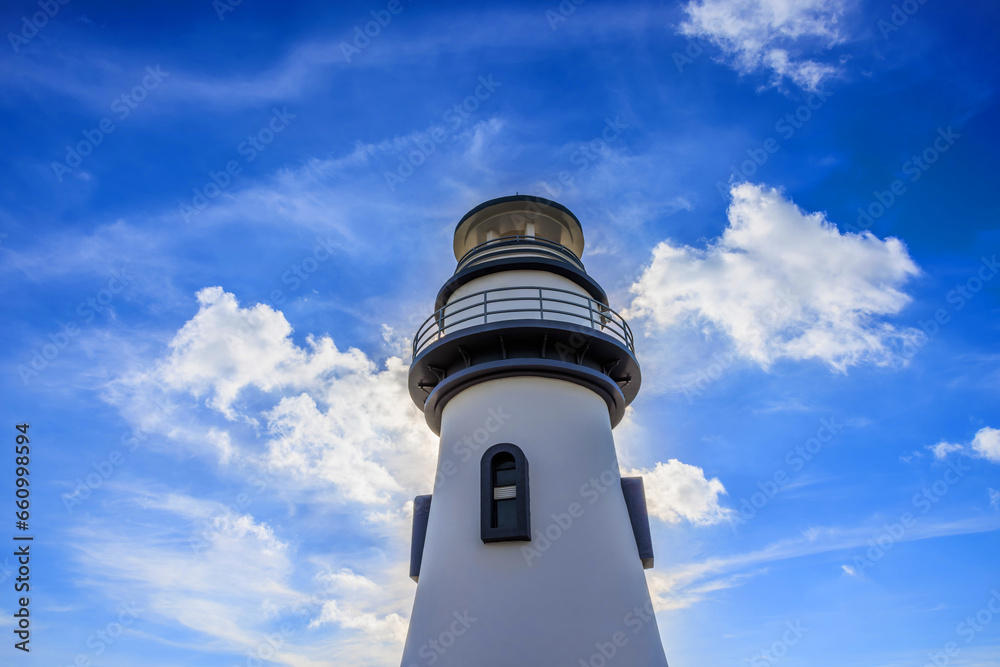 Low angle shot of lighthouse building under blue sky Low angle shot of lighthouse building under blue sky