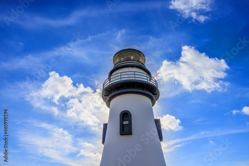Low angle shot of lighthouse building under blue sky