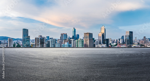 Asphalt road and city skyline with modern buildings scenery at sunset © ABCDstock