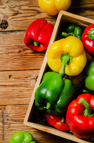 Fresh sweet pepper. On wooden table.