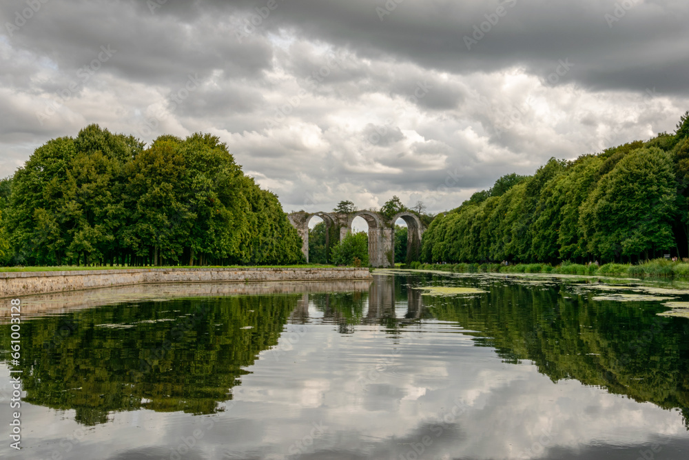 Green summer landscape with a river and trees and an aqueduct Green summer landscape with a river and trees and an aqueduct