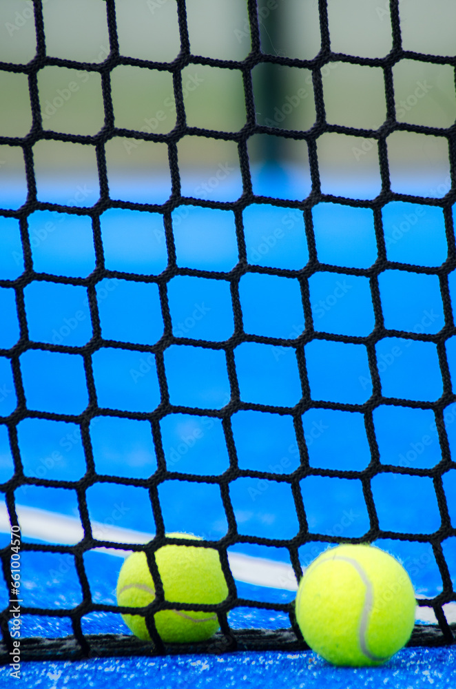 Two paddle tennis ball near the net, racket sports