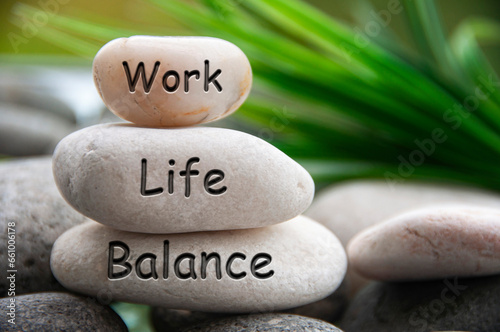 Work life balance text engraved on white stones. Work, lifestyle and life balance concept. photo
