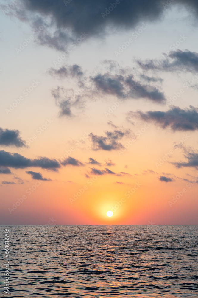 Beautiful warm sunset on the sea. Vertical photo