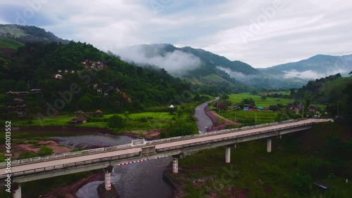 Aerial drone view of Concrete bridge over the canal at Ban Sapan, Small village in Nan, THAILAND.