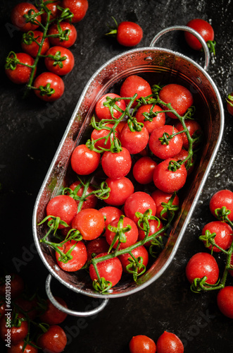 Fresh tomatoes. On black table.