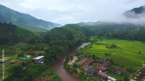Aerial drone view of Wonderful natural scenery captured in morning with fog. A mountain rapids on the river at Ban Sapan, Small village in Nan, THAILAND. (Clip 03)