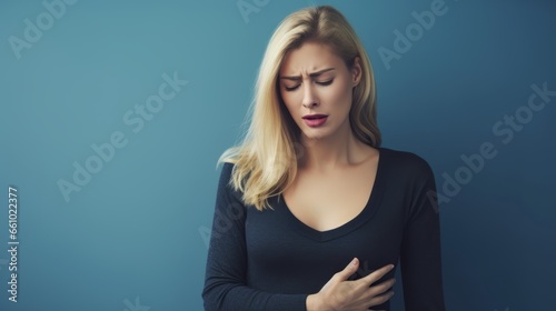 A blonde woman holding her chest in pain.generative ai
 photo