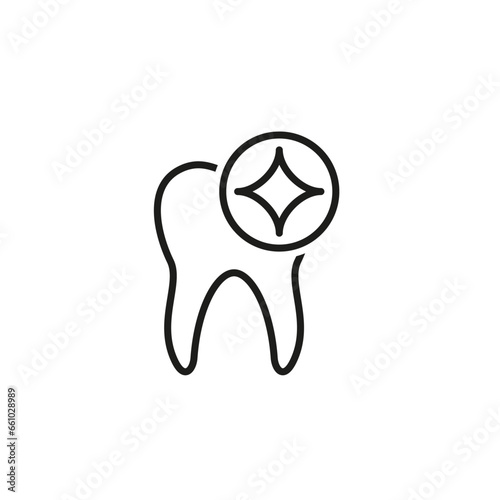 A human tooth with a glare and sparkling star.