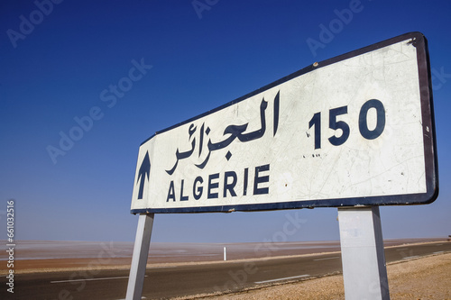 Distance sign on causeway on Chott El Jerid endorheic salt lake in southern Tunisia