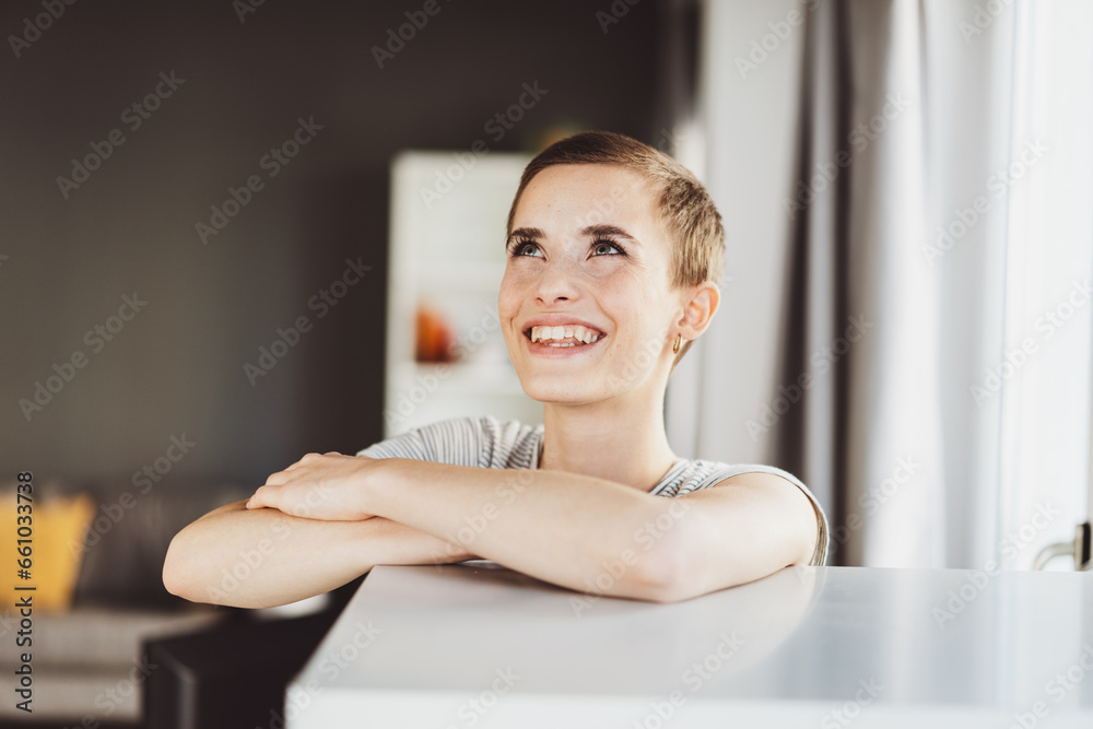 Stylish Modern Young Woman with Short Hair Leaning on Office Cabinet, Laughing Upward Stylish Modern Young Woman with Short Hair Leaning on Office Cabinet, Laughing Upward