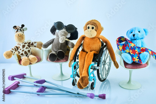 Fototapeta Naklejka Na Ścianę i Meble -  International day of persons with disabilities. Wheelchair with toys sign of different disabilities on blue background.