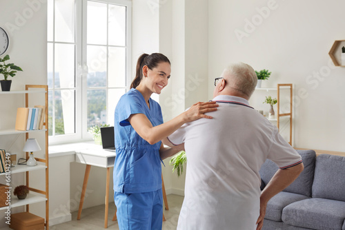 Old people therapy, physical exercise for rehabilitation at home. Senior man physiotherapy training with nurse. Woman caregiver or nurse physiotherapist in uniform helping aged man patient. © Studio Romantic