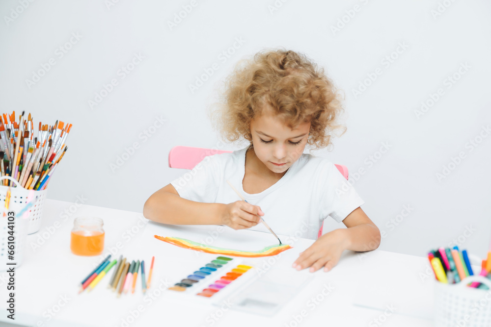 Cute little blonde preschooler girl draws at home Cute little blonde preschooler girl draws at home