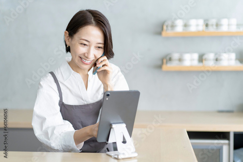 カフェで働く女性　電話　予約 photo