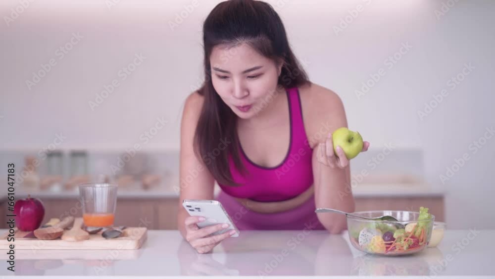 sporty young Asian woman in sportswear eating apple and using smartphone, Sport and Technology concept. Lifestyles and Healthcare. sporty young Asian woman in sportswear eating apple and using smartphone, Sport and Technology concept. Lifestyles and Healthcare.