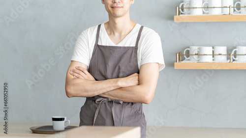 カウンターに立つカフェ店員男性 BAR