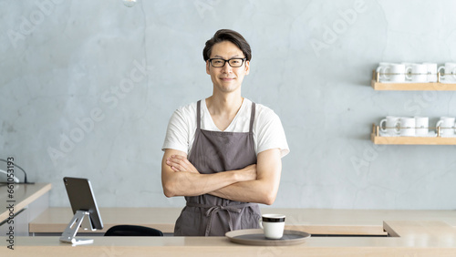 カウンターに立つカフェ店員男性　BAR photo