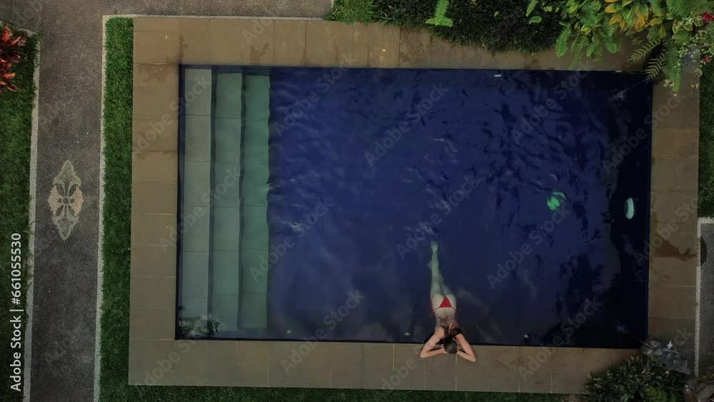Vidéo Stock Aerial view of a young beautiful woman in a red bikini ...