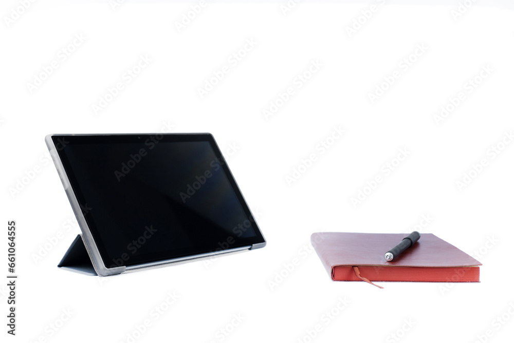Tablet, notebook and pen on a white background. Isolated. Tablet, notebook and pen on a white background. Isolated.