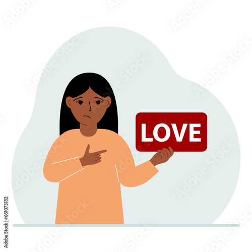 Little girl is holding a red banner with love text. The concept of valentine's day, holiday, psychological help.