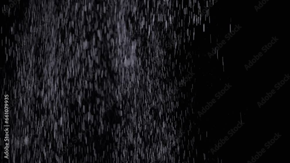Heavy Snowfall, Stream of Falling Particles in Empty Space on Black Background. Falling Whirlpool of Mixed Particles of dust, snow, debris. Collision, rotate, swirl. Copy space. Blurred movement.