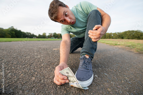 Money under your feet. Find and lose one hundred dollars near boots on the road.