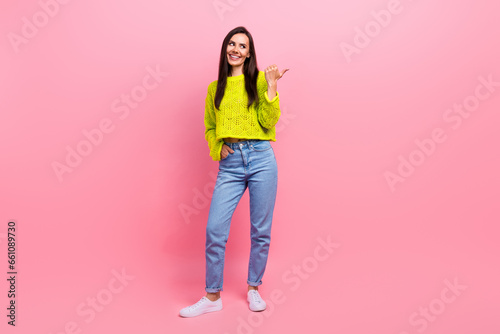 Photo of pretty cheerful girl wear yellow autumn outfit thumb direct empty space special offer isolated on pink color background