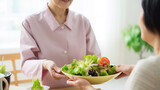 Meal Preparation: A caregiver assists in preparing a meal with an elderly person