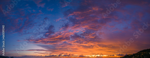 ..aerial panorama view amazing cloud with purple shadow in blue sky during beautiful sunset..Gradient color. abstract nature background..Scene of colorful orange light trough in the sky background. © Narong Niemhom