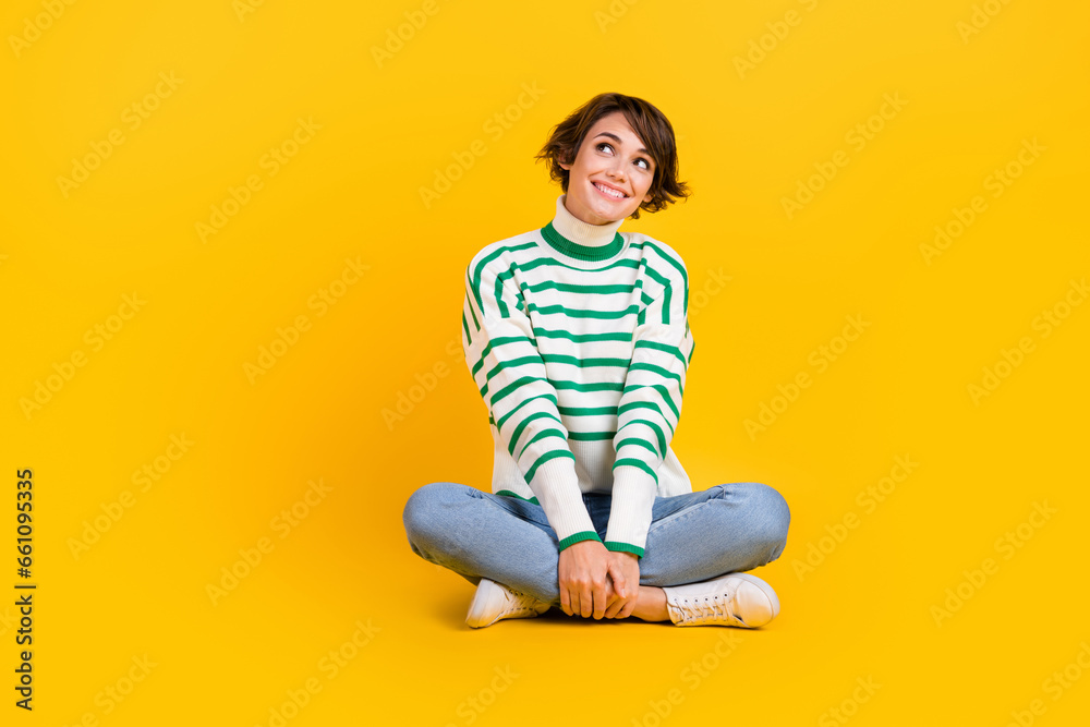 Full body cadre of candid pretty person girlfriend sit floor thinking dream look empty space message isolated on yellow color background Full body cadre of candid pretty person girlfriend sit floor thinking dream look empty space message isolated on yellow color background