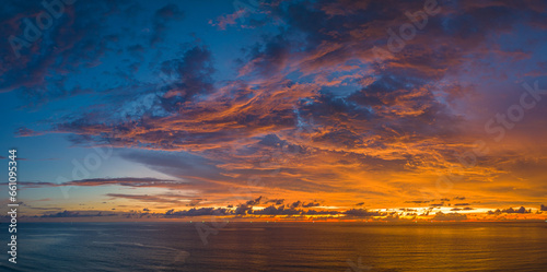 ..aerial panorama view amazing cloud with purple shadow in blue sky during beautiful sunset..Gradient color. abstract nature background..Scene of colorful orange light trough in the sky background.