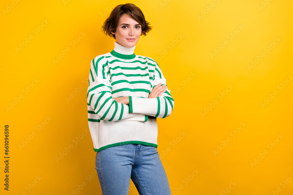 Photo of cool confident lady wear striped pullover arms crossed empty space isolated yellow color background Photo of cool confident lady wear striped pullover arms crossed empty space isolated yellow color background