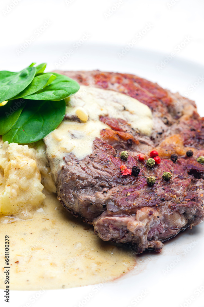 beef steak with sauce, mashed potatoes and spinach leaves beef steak with sauce, mashed potatoes and spinach leaves