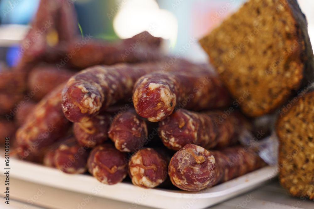 The market offers raw smoked sausages and bread. The market offers raw smoked sausages and bread.