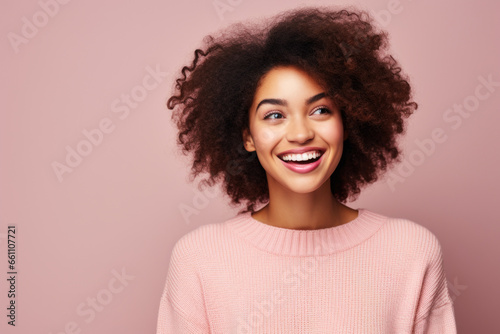 Radiant Gaze: A Young African American Woman Smiling and Looking Away, Set Against a Pink Background in a Trendy Studio Portrait