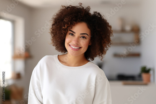 A happy plus size,  african woman, she is wearing a plain white mockup unisex sweatshirt showcasing, brazilian woman at home photo
