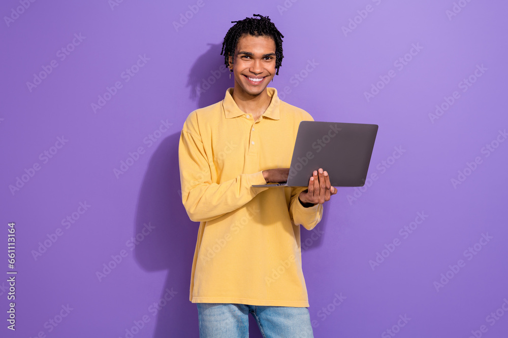 Photo of clever focused cool person with cornrows wear stylish shirt look at laptop texting email isolated on purple color background