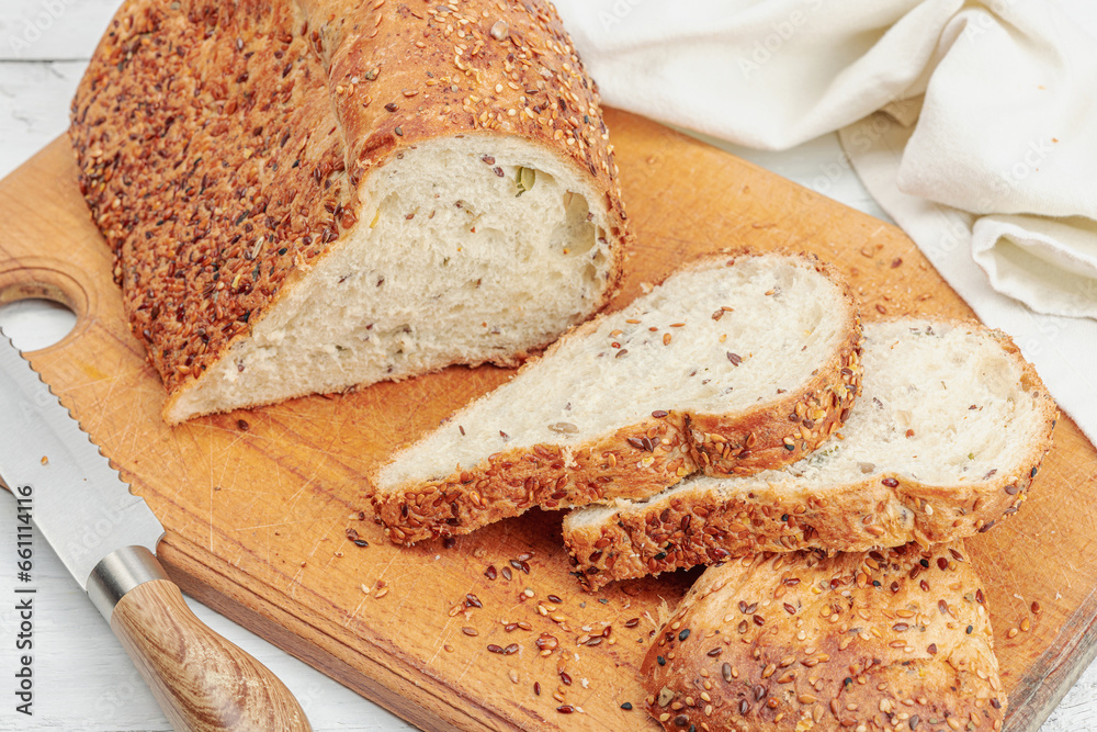 Fresh bread with with various seeds. Home baking gluten free concept, hobby. Wooden cutting board Fresh bread with with various seeds. Home baking gluten free concept, hobby. Wooden cutting board
