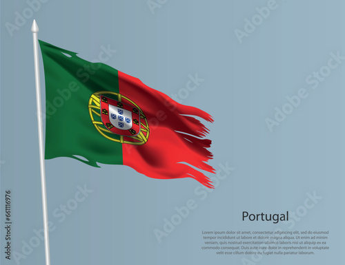 Ragged national flag of Portugal. Wavy torn fabric on blue background