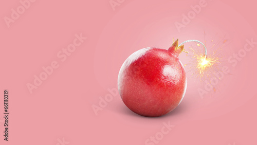 Creative juicy pomegranate bomb with wick and sparks burning, concept. Juicy explosion of vitamin and health, creative idea. Healthy eating and diet photo