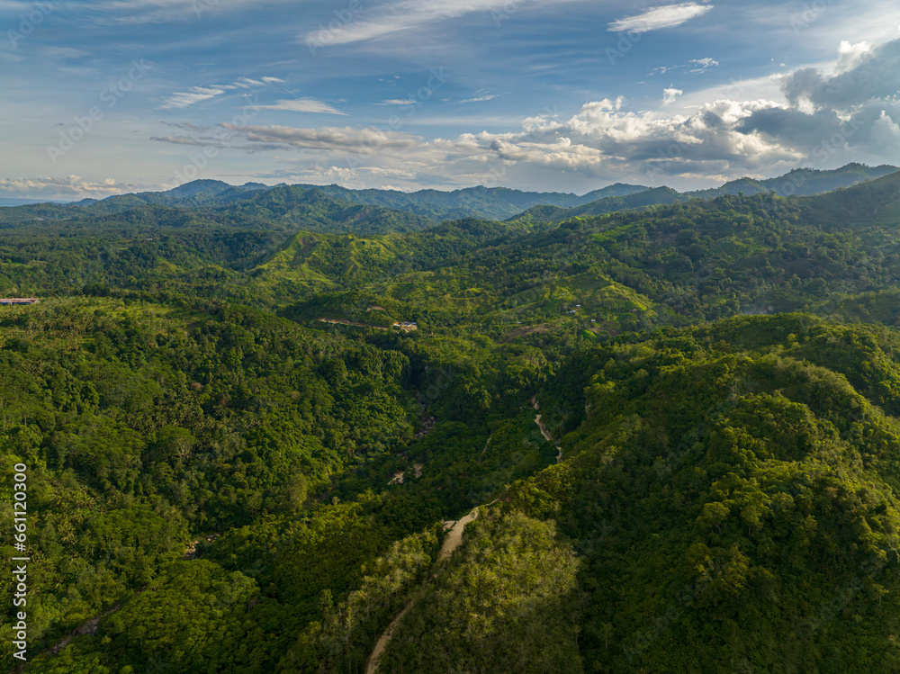 River and mountain rainforest. Blue sky and clouds. Mindanao, Philippines.